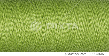 macro texture of a skein of green sewing thread 133586070