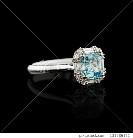 Beautiful white gold ring with diamonds and aquamarine on a black background 133586131