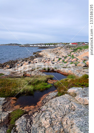 Traditional wooden houses near marina on peaceful car-free Vrango island with seaside village in Gothenburg archipelago, Sweden Traditional wooden houses near marina on peaceful car-free Vrango island with seaside village in Gothenburg archipelago, Sweden 133586195