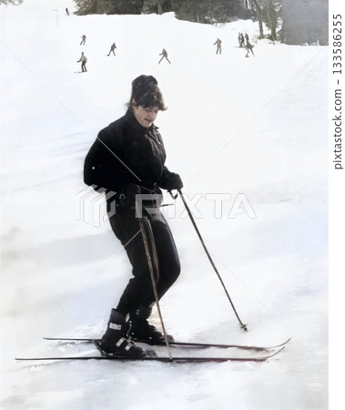 A vintage portrait of a young female skier on a snowy mountain slope. Photo from 1985. 133586255