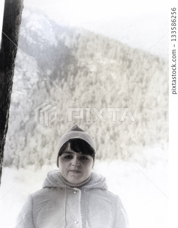 Vintage portrait of a young female athlete after training at a ski camp. Tiberda, USSR. Retro photo from 1985. 133586256