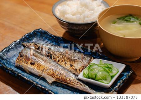 Japanese-style dinner of grilled saury and cucumber in vinegar, served with rice and miso soup Japanese-style dinner of grilled saury and cucumber in vinegar, served with rice and miso soup 133587073
