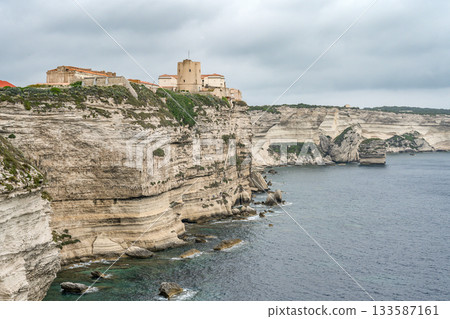 Aerial view marina cape Bonifacio south Corsica France citadel on rocky promontory on wild white limestone cliffs 133587161