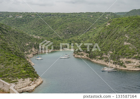 Aerial view marina cape Bonifacio south Corsica France citadel on rocky promontory on wild white limestone cliffs 133587164