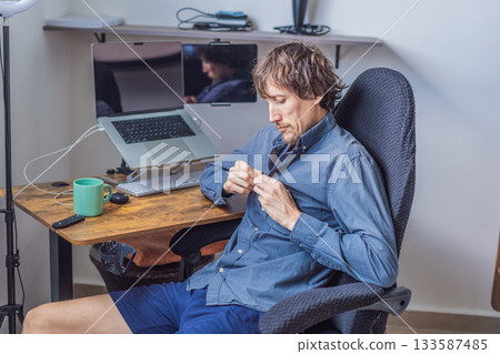 A man working from home in his organized home office, focused on his laptop in a bright modern workspace. Remote work, productivity, freelance lifestyle and contemporary global workplace concept 133587485