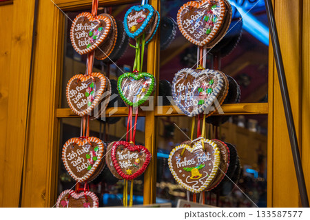 Traditional german lebkuchenherzen with messages: Ich habe dich lieb, Frohes Fest (I love you, Happy holidays) at a festive christmas market stall. Heart-shaped gingerbreads Traditional german lebkuchenherzen with messages: Ich habe dich lieb, Frohes Fest (I love you, Happy holidays) at a festive christmas market stall. Heart-shaped gingerbreads 133587577