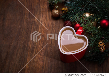Heart Mug Holiday Scene. Heart-shaped mug with coffee, surrounded by festive holiday decorations 133587675