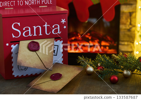 Santa's Mailbox. Festive mailbox with letters for Santa by a cozy fireplace, surrounded by holiday decor. Santa's Mailbox. Festive mailbox with letters for Santa by a cozy fireplace, surrounded by holiday decor. 133587687
