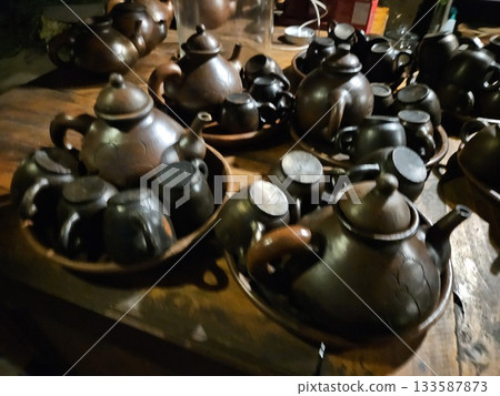 This is a group of clay teapot with black colour 133587873
