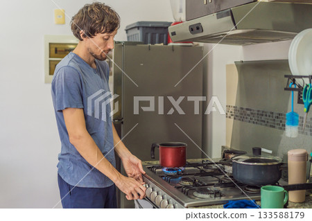 Man preparing lunch in an authentic modern kitchen with character, cutting ingredients and cooking a homemade meal in a warm family atmosphere 133588179