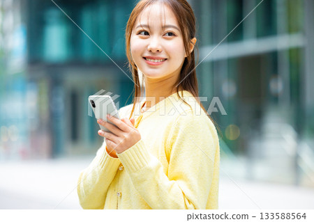 Woman holding a smartphone Woman holding a smartphone 133588564