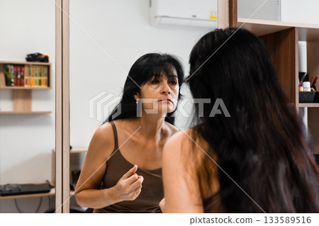 50 year old russian woman looking at mirror 133589516