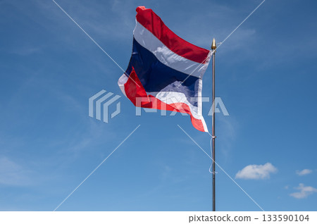 A Thailand national flag blowing by wind against blue sky. The flag of Thailand is a symbol of being a country. 133590104