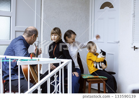 father of real family playing guitar singing, lifestyle people concept 133590139