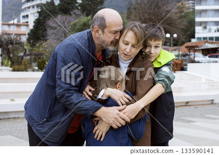 happy real family hugging outside, lifestyle people concept 133590141