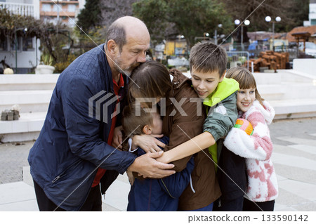 happy real family hugging outside, lifestyle people concept 133590142