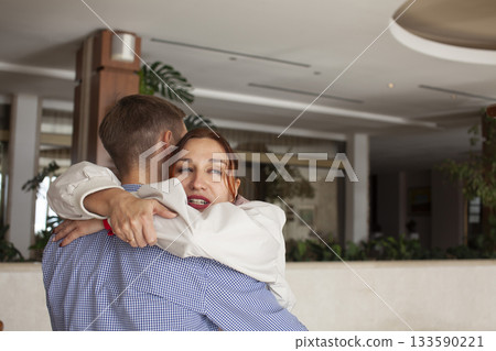 young couple checking in hotel lobby, lifestyle people concept young couple checking in hotel lobby, lifestyle people concept 133590221