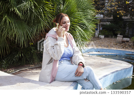 young pretty woman talking on phone at swimming pool, lifestyle people concept young pretty woman talking on phone at swimming pool, lifestyle people concept 133590357