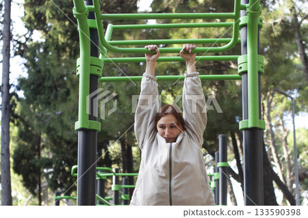 young pretty redhead woman making fitness on playground outside, lifestyle people concept 133590398
