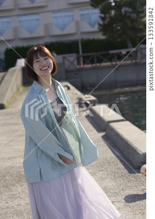 A woman walking along the beach 133591842