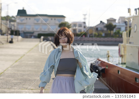 A woman walking along the beach A woman walking along the beach 133591843