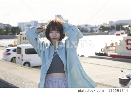 A woman walking along the beach A woman walking along the beach 133591844