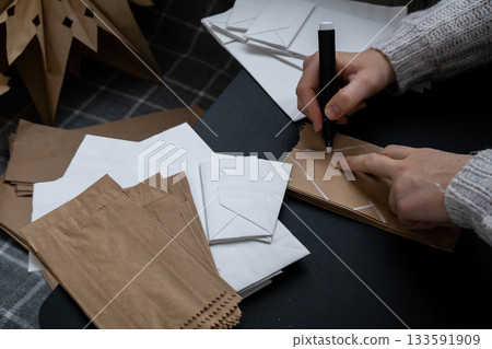 Process of preparing for Christmas star and New Year eve. 3D craft bag snowflakes DIY. Responsible ecological zero waste handmade decoration. Children hobby activity 133591909