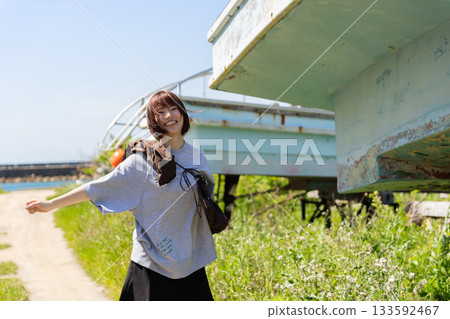Woman walking along the seaside path 133592467
