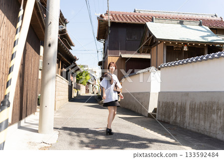 Woman walking up a slope 133592484