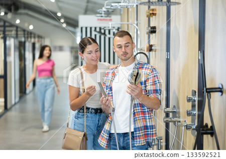 Married couple, husband and wife, chooses shower head in hardware store 133592521