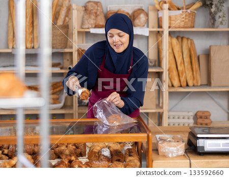 Muslim saleswoman behind the counter in a bakery 133592660