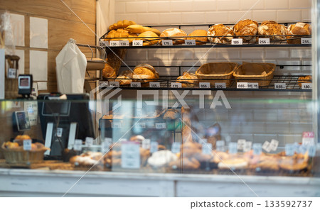 Showcase of Spanish bakery shop with appetizing croissants, baguette and buns 133592737