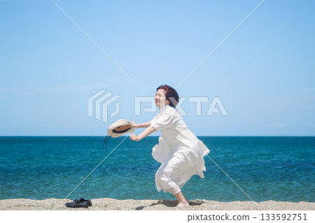 Smiling woman having fun at the beach Smiling woman having fun at the beach 133592751