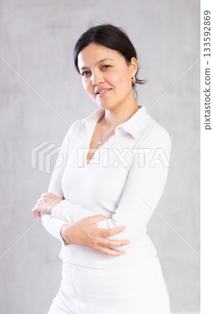 Portrait of young woman in casual clothes posing in studio 133592869