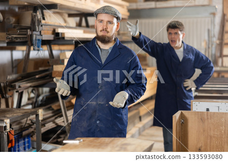 Young male carpenters quarreling in workshop Young male carpenters quarreling in workshop 133593080