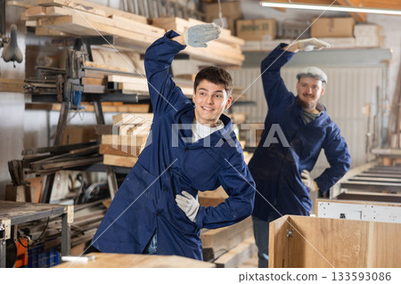 Two funny sawmill workers perform various funny moves Two funny sawmill workers perform various funny moves 133593086