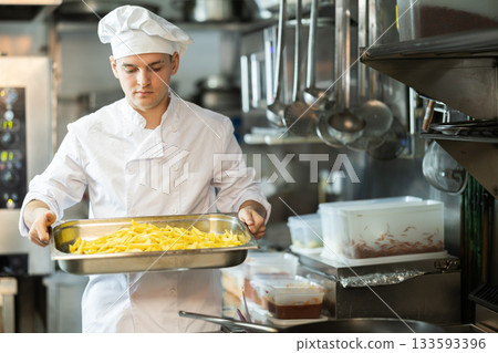 Young man cooker work at kitchen 133593396