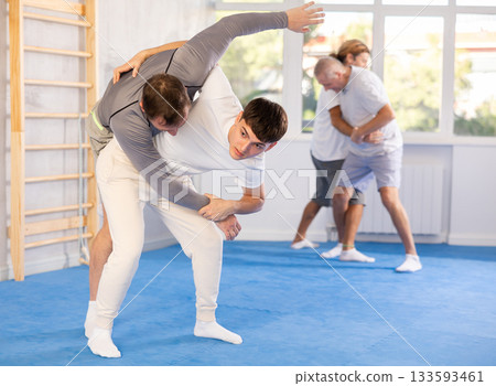 Two men training judo technique in studio 133593461