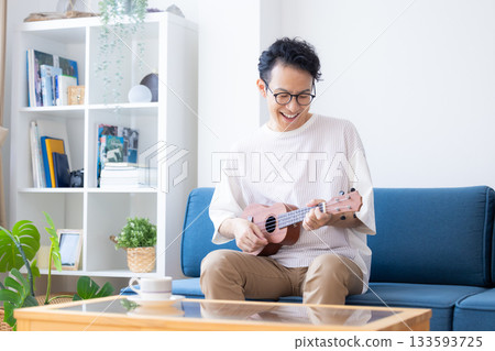 Man playing the ukulele Man playing the ukulele 133593725