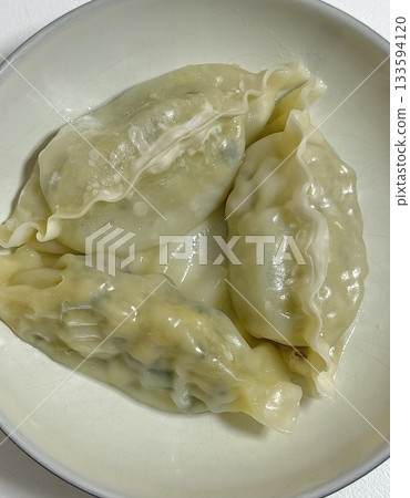 Delicious Korean mandu dumplings with a golden, crispy exterior and flavorful filling. Perfect as an appetizer, snack, or side dish, offering a delightful taste in every bite. 133594120