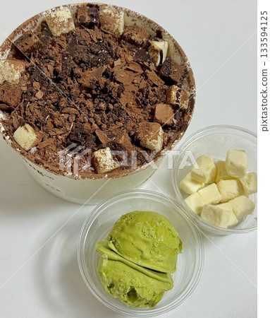 Rich and indulgent chocolate bingsu topped with chocolate syrup, brownie chunks, and chocolate shavings. A heavenly treat for chocoholics seeking a cool and creamy dessert escape. 133594125