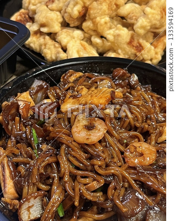 A classic Korean-Chinese combo of jajangmyeon with thick, chewy noodles coated in rich black bean sauce, served alongside crispy tangsuyuk, deep-fried pork with sweet and sour sauce. 133594169