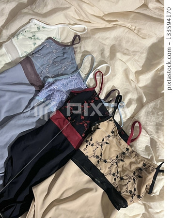 Colorful swimsuit with sleek fabric and smooth contours, highlighting its vibrant design, soft texture, and stylish form in close-up detail 133594170