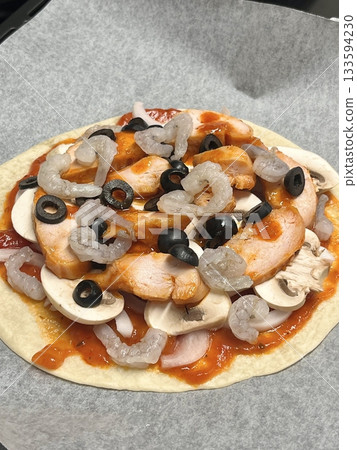 A delicious pizza with a golden crust, melted cheese, and savory toppings. Perfect for food-related designs, menus, or Italian-themed projects, capturing the essence of a classic comfort dish. 133594230