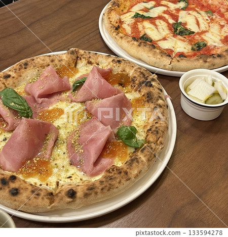 A delicious pizza with a golden crust, melted cheese, and savory toppings. Perfect for food-related designs, menus, or Italian-themed projects, capturing the essence of a classic comfort dish. 133594278