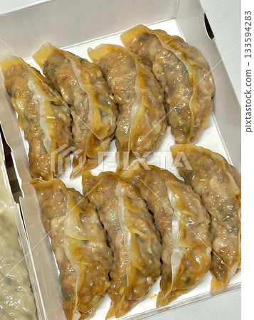 Korean dumplings filled with a mix of savory ingredients like ground meat, tofu, and vegetables. Mandu can be steamed, boiled, or pan-fried, making it a versatile and delicious snack or meal. Korean dumplings filled with a mix of savory ingredients like ground meat, tofu, and vegetables. Mandu can be steamed, boiled, or pan-fried, making it a versatile and delicious snack or meal. 133594283