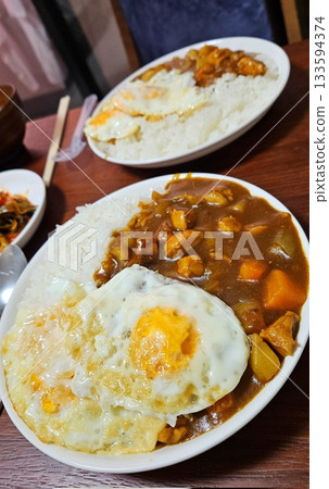 A comforting bowl of Japanese curry, featuring a rich, savory sauce with tender vegetables and chunks of meat, served over fluffy rice. A warm, flavorful dish perfect for any meal. A comforting bowl of Japanese curry, featuring a rich, savory sauce with tender vegetables and chunks of meat, served over fluffy rice. A warm, flavorful dish perfect for any meal. 133594374