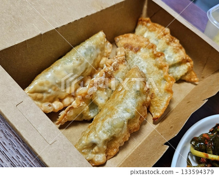 Delicious Korean mandu dumplings with a golden, crispy exterior and flavorful filling. Perfect as an appetizer, snack, or side dish, offering a delightful taste in every bite. Delicious Korean mandu dumplings with a golden, crispy exterior and flavorful filling. Perfect as an appetizer, snack, or side dish, offering a delightful taste in every bite. 133594379