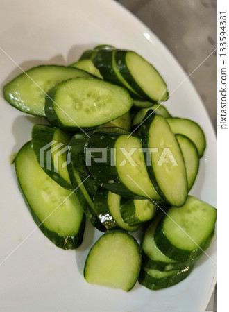 Fresh cucumbers with a crisp texture and mild, refreshing taste. Ideal for salads, pickles, or as a hydrating snack. Versatile and packed with nutrients. 133594381