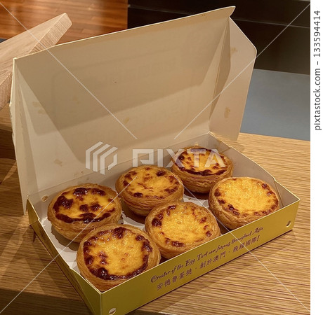 Golden egg tart with a flaky, buttery crust and a rich, creamy custard center. A deliciously satisfying treat for dessert or a light snack, blending texture and flavor perfectly. 133594414
